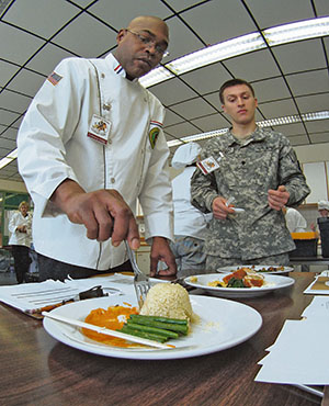 Chef Christopher Rolack, Culinary Arts Fair judge, tastes a rice dish prepared by one of the teams visiting Baumholder during the second annual Culinary Arts Fair Feb. 13.