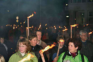 Participants of the burning of winter event in Olsbrücken walk with torches up to Oberberg hill where the bonfire is lit.