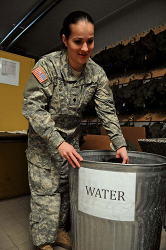Photos by Staff Sgt. Alexander Burnett Spc. Mariafernanda Romero, the chemical, biological, radiological and nuclear NCO in charge of Headquarters and Headquarters company, 21st Special Troops Battalion, 21st Theater Sustainment Command, dips an M40/A1 protective mask in water during a cleaning procedure Feb. 26 on Daener Kaserne. Soldiers from the 21st TSC have their protective masks serviced and inspected twice a year to ensure they remain in working condition. The regularly scheduled maintenance includes mask cleaning, drying, reassembly and testing.