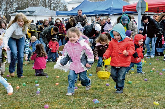 Children rush to fill their Easter baskets during last year’s Easter egg hunt at Baumholder’s Iron Soldier Park.