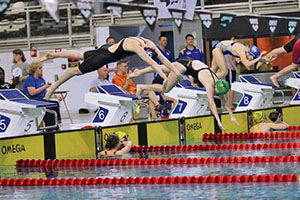 Photo by Nathan Davis Kaiserslautern Kingfish swimmer Lexy Meints jumps off the blocks in the 200-meter freestyle, in which she set a new team record.