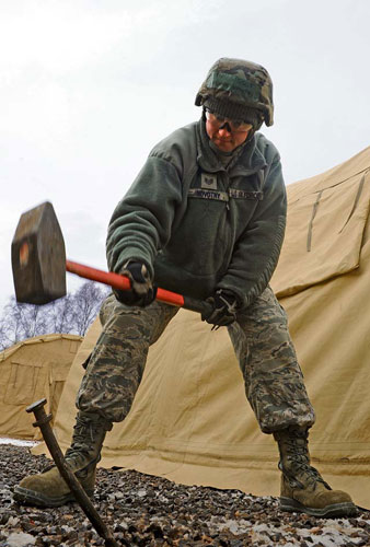 Senior Master Sgt. David Dubyak, 48th Civil Engineer Squadron facility superintendent, ties down a cover to a tent during the Silver Flag training exercise Tuesday on Ramstein. The purpose of Silver Flag is to prepare Airmen for any type of bare-base deployment.