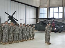 Soldiers from Company C, 1st Battalion, 214th Aviation Regiment bow their heads during the chaplain’s prayer inside the aircraft hangar at the Landstuhl heliport.