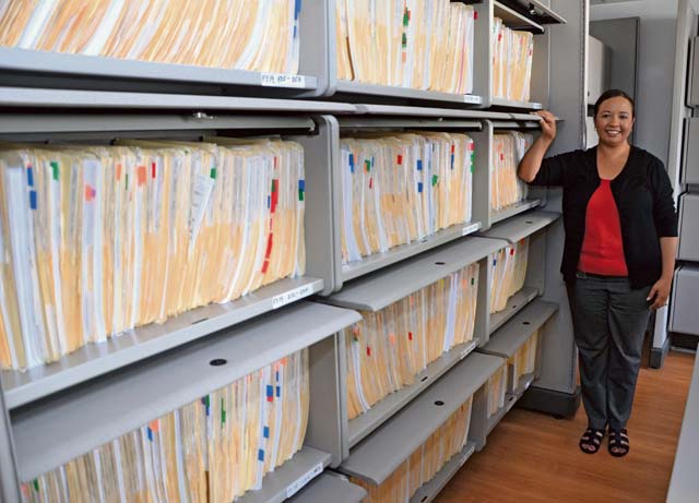 Europe Regional Medical Command Exceptional Family Member Program director Leslie Garcia shows what one year's worth of EFMP family travel requests look like when filed.  