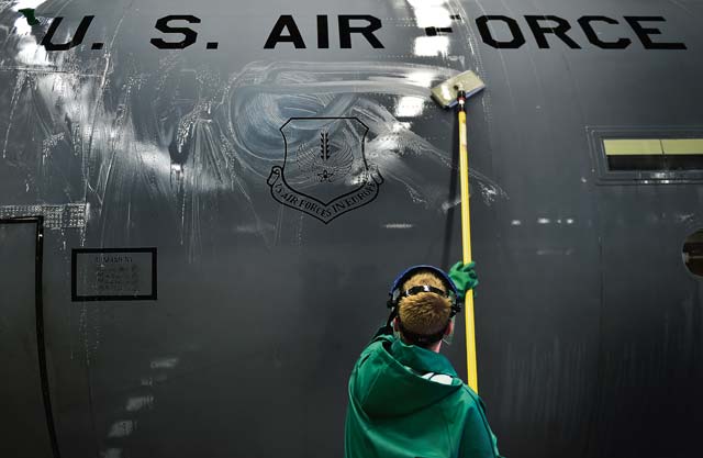 An Airman from the 86th Aircraft Maintenance Squadron washes the side of a C-130J Super Hercules.