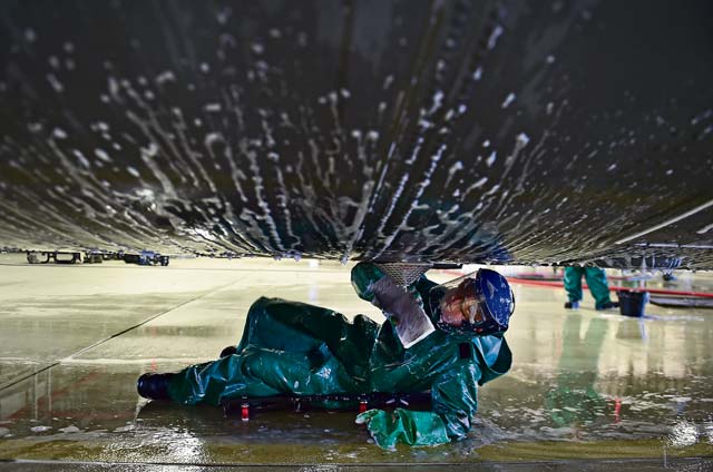 An Airman from the 86th Aircraft Maintenance Squadron washes the underside of a C-130J Super Hercules.