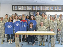Ramstein High School students, staff, and 86th Communications Squadron service members pose for a group photo after signing an Adopt-a-School Partnership Memorandum of Understanding May 31 on Ramstein Air Base. The Adopt-a-School program is a voluntary, ongoing partnership between a school and a military unit to foster a mutually beneficial partnership between the students and the Airmen and Soldiers of the Kaiserslautern Military Community.