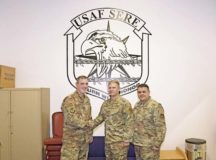 Brig. Gen. Mark August, 86th Airlift Wing commander, poses for a photo with U.S. Air Force Staff Sgt. Christian Martin, 86th Operation Support Squadron Survival, Evasion, Resistance, and Escape Training non-commissioned officer in charge, in recognition of Martin receiving Airlifter of the Week Oct. 31, on Ramstein Air Base. Martin maintains just under one million dollars worth of facilities and training equipment in order to sustain aircrew currencies for missions spanning three geographic combatant commands.