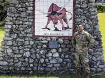 U.S. Air Force Master Sgt. Carlos Torres, 65th Air Base Squadron maintenance superintendent, poses for a photo near his unit's mural. Torres received the Ramstein Air Base Airlifter of the Week award in recognition for his work during the pandemic. Photo by Master Sgt. Torres