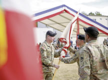 Commanding Maj. Gen. Chris Mohan of the 21st Theater Sustainment Command passes the brigade guidon colors to incoming commander Col. Brad A. Bane of the 405th Army Field Support. The passing of the guidon symbolizes the passing of command from the outgoing commander to the incoming commander.