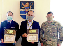 Steffen Andres, Lingenfeld Fire Chief, left, and Dr. Fritz Brechtel, Germersheim County Commissioner, pose with Col. Jason Edwards, U.S. Army Garrison Rheinland-Pfalz commander, after Edwards presented Keys to the Garrison to the gentlemen in a small ceremony in late June. Photo by Stefan Alford