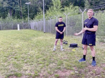Sgt. 1st Class Brandon Johnson, assigned to the 11th Missile Defense Battery, 10th Army Air and Missile Defense Command, teaches form and technique about the sprint, drag, carry ACFT event at Ramstein Air Base, on July 29.