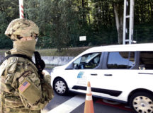 Pfc. Samuil Matveen, Headquarters and Headquarters Company, USAG Rheinland-Pfalz, stands guard, backing up the contract gate guards, at a Pulaski Barracks gate in Kaiserslautern, as part of a Troop Diversion exercise during Anti-Terrorism/Force Protection Month.