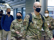 Passengers depart from an aircraft in the Ramstein Passenger Terminal at Ramstein Air Base, Germany, Dec. 9, 2020. As part of COVID-19 guidelines, all visitors are required to wear face coverings. (U.S. Air Force photo by Airman 1st Class Taylor D. Slater)