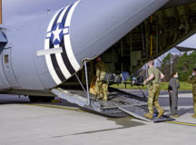 Airmen assigned to the 86th Airlift Wing load various in-flight kits onto a C-130J Super Hercules aircraft at Ramstein Air Base, Germany, Feb. 4, 2021. The kits include medical supplies, patient comfort items and personal protection equipment. The NPC-L fits into the cargo compartment of C-130Js, and is designed to transport individuals with COVID-19 or other highly infectious diseases while preventing the aircrew and medical professionals onboard from exposure. (U.S. Air Force photo by Senior Airman Jennifer Gonzales)