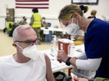 Andreas Heinze, 721st Aerial Port Squadron motor carrier safety specialist, receives a COVID-19 vaccine shot from Iris Geist, a German local national nurse, at Ramstein Air Base, Germany, April 29, 2021. This marks the first time local national members were able to volunteer to receive a COVID-19 vaccine from the installation. Ramstein is the first base in U.S. Air Forces in Europe to vaccinate its local national workforce. (U.S. Air Force photo by Senior Airman Milton Hamilton)