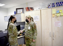 U.S. Air Force Airman 1st Class Kiera Christensen, 86 Medical Support Squadron patient movement technician, right, accepts a coin from 86th Airlift Wing Command Chief Master Sgt. Hope Skibitsky at Ramstein Air Base, Germany, May 20, 2021. As one of only two Airmen, Christensen manages the Air Force’s second-largest Patient Movement Operations mission, supporting 34 countries and 97 locations across three combatant commands. (U.S. Air Force photo by Airman 1st Class Alexcia Givens)