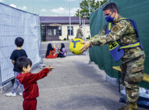 Airman 1st Class Christopher Uhrich, 86th Security Forces Squadron defender, plays with a child at Ramstein Air Base, Germany, Aug. 25, 2021. Security Forces members ensure that evacuees are safe and protected at their temporary lodging during Operation Allies Refuge.