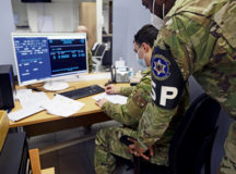 A 569th United States Forces Police Squadron Vehicle Registration clerks look over a customer’s paperwork at Kapaun Air Station, Jan. 24. The 569 USFPS created two QR codes to increase efficiency and save time.