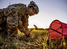 U.S. Air Force Tech. Sgt. Josh Griffith, 435th Contingency Response Squadron airborne air traffic controller, secures a visual airfield marking along the landing zone during exercise Agile Wolf 22 at Koszalin, Poland, Sept. 13, 2022. Visual markers are placed along the flightline to show the aircraft where it is safe to touchdown on a landing zone. (U.S. Air Force photo by Airman 1st Class Jared Lovett)