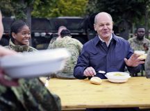 Sgt. 1st Class Terysa King, 21st Theater Sustainment Command Public Affairs operations noncommissioned officer (l), shares lunch with German Chancellor Olaf Scholz Oct. 23, 2023, during an all-day Bundeswehr capabilities demonstration and media day at Luftwaffen Kaserne in Koln-Wahn, Germany. As an Army public affairs specialist stationed in Germany, King coordinates media outreach activities with U.S. allies throughout Europe. (Bundeswehr courtesy photo).