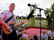 U.S. Air Force Staff Sgt. Clifton Wright, U.S. Air Forces in Europe - Air Forces Africa Band guitarist, plays his guitar during a classic rock concert at Neunkirchen, Germany, Aug. 9, 2024. The concerts provide an opportunity for building bridges between different communities and fostering mutual understanding through the universal language of music. (U.S. Air Force photo by Senior Airman Edgar Grimaldo)