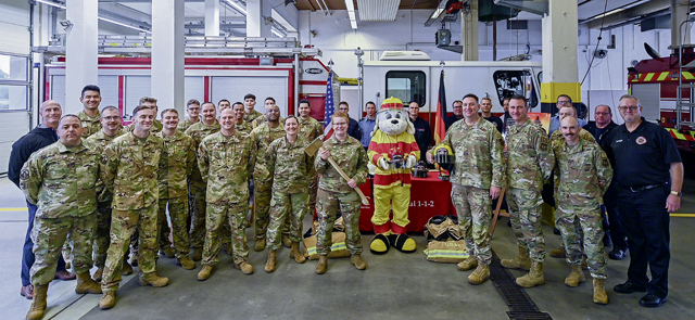 86th Airlift Wing leadership pose for a group photo with military personnel assigned to the 86th Civil Engineer Squadron at Ramstein Air Base, Germany, Oct. 2, 2024. U.S. Air Force Lt. Col. Katherine M. Paulson, 86th Civil Engineer Squadron commander and fire marshal, proclaimed Williams as the honorary fire marshal, and as fire marshal, Williams has declared Oct. 5-19, as the 2024 fire prevention week. (U.S. Air Force photo by Senior Airman Edgar Grimaldo)