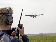 U.S. Air Force Staff Sgt. Brayden Crabtree, 86th Operations Support Squadron complex watch supervisor, communicates with an incoming Polish C-130H Hercules at Leszno Airfield, Poland, during Aviation Rotation Detachment 24-4, Sept. 16, 2024. Bilateral training exercises like ADR provide opportunities to practice information sharing and communication in simulated scenarios, helping to improve interoperability and strengthen trust among allies. (U.S. Air Force Photo by Airman 1st Class Trevor Calvert)