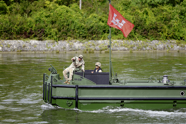 Sgt. Daniel Beltran, a bridge crewmember crew chief assigned to the 809th Multi-Role Bridge Company, gives directions from his M30 Bridge Erection Boat during a bridging equipment field testing exercise on the Danube River in Ingolstadt, Germany, from 12-25 Sept.