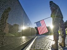 A U.S. Army Reservist reads some of the 58,307 names etched into "the Wall" of the Vietnam Veterans Memorial as the sun rises in Washington, July 22, 2015.Photo by Army Sgt. Ken Scar