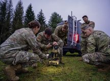 U.S. Air Force Senior Airman Lance Smith, center, 1st Combat Communications Squadron tactical communications technician, sets up a PANTHER 2, Very Small Aperture Terminal (VSAT) satellite at Hohenfels Joint Multinational Readiness Center, Germany, Oct. 28, 2024. The PANTHER is used to achieve communication capabilities in support of austere landing zone operations. (U.S. Air Force photo by Senior Airman Brenden Beezley)