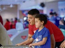 U.S. Air Force 1st Lt. Kalvin Bazan, 700th Contracting Squadron deputy flight commander, assists a child at a Special Olympics tribute bowling event at Vogelweh Military Complex, Germany, Dec. 4, 2024. This event provided service members and children with disabilities from across the Kaiserslautern Military Community a chance to interact with each other to build relationships. (U.S. Air Force photo by Airman 1st Class Trevor Calvert)