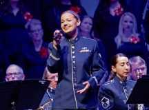 U.S. Air Force Senior Airman Natalie Angst, U.S. Air Forces in Europe - Air Forces Africa Band vocalist, sings during the Kaiserslautern Military Community Christmas concert at the Fruchthalle in Kaiserslautern, Germany, Dec. 13, 2024. These concerts offer a personal stage for cultural exchange and fellowship of musical traditions between the U.S. Air Force musicians and European audiences. (U.S. Air Force photo by Senior Airman Renan Arredondo)