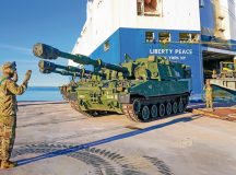 M109 Paladin driver Pfc. Sterling Maness and ground-guide Staff Sgt. Stephon McIntosh communicate through hand signals to stage the howitzer at its proper location within the staging yard during offloading operations at the port of Koper, Slovenia on December 28, 2024. This Reception, Staging, and Onward Movement (RSOM) operation in the port of Koper is bringing in 1-3ID, the next Regionally Aligned Force (RAF), into the European Theater. These forces will be then transported by the 21st Theater Sustainment Command to their forward operating sites across NATO where they will conduct interoperability training with Allies and partners. The intent of these RAFs is to assure our allies and deter all adversaries.