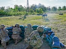 U.S. Air Force Airmen, from the 435th Contingency Response Element, remain vigilant behind sandbags as a "robot dog" gathers information during exercise Swift Response 24, at Kecskemet Air Base, Hungary, May 10, 2024. SR24 is a joint exercise that enables members of NATO to build strong partnerships and test new technology (U.S. Air Force photo by Captain Jacob Murray)